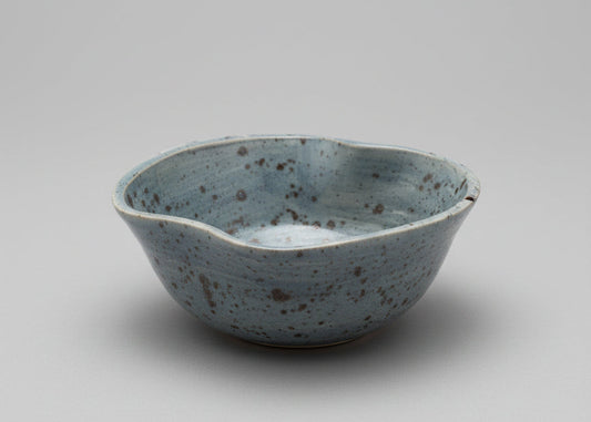 Speckled ceramic bowl on a white surface