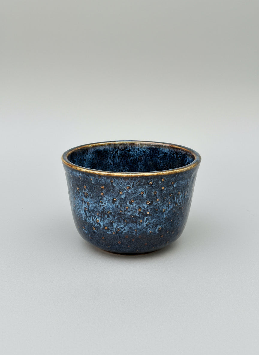 Blue ceramic bowl on a light gray background