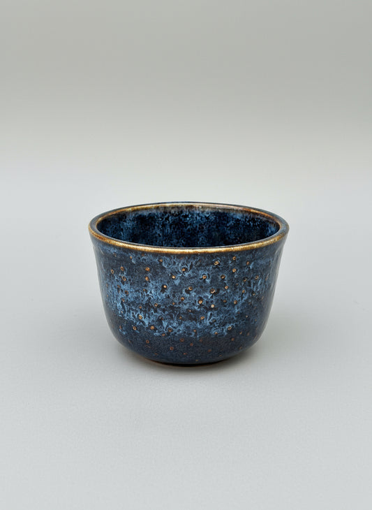 Blue ceramic bowl on a light gray background